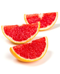 cut red grapefruit isolated on white