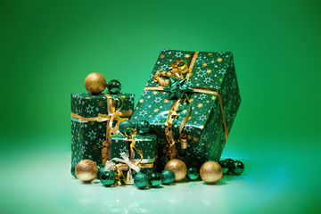 Gift boxes and christmas balls,Isolated on green background