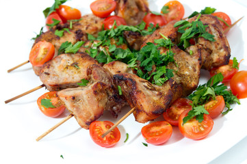 Barbecue on skewers, garnished with cherry