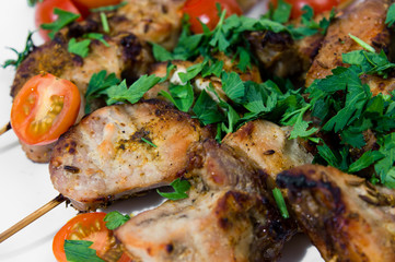 Barbecue on skewers, garnished with cherry