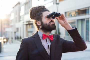 Stylish elegant dreadlocks businessman binoculars