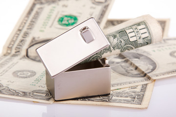 Naklejka premium Many dollar banknotes, house model; concept of buying a house