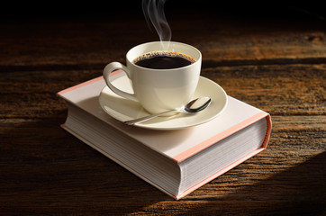 Cup of coffee on a book-like box.