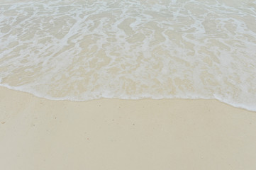 Sea wave over sand