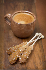 cup of coffee and caramel sugar on sticks, selective focus