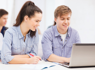 Fototapeta premium students with laptop and notebooks at school
