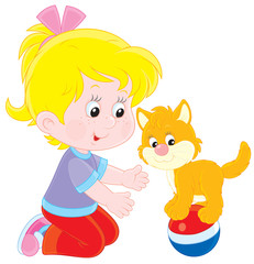 Little girl playing with her small kitten