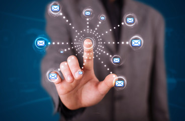 Businessman pressing virtual messaging type of icons