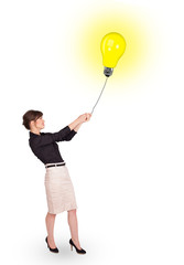 Happy woman holding a light bulb balloon