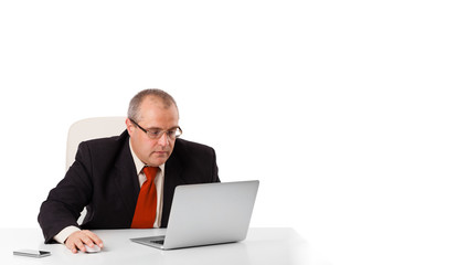 buisnessman sitting at desk and looking laptop with copy space