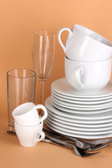 Clean white dishes on beige background