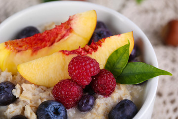 Oatmeal in cup with berries on napkins
