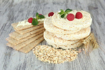 Tasty crispbread with berries, on wooden table
