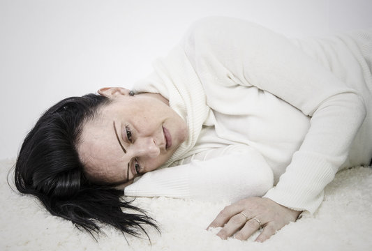 depressed woman lying on floor with copy space