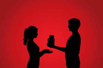 Silhouettes of couple with gift