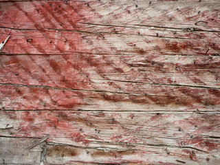 sun-bleached red paint on wood, background, old and rustic