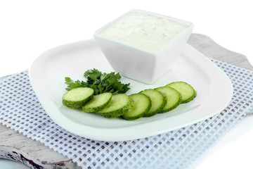 Cucumber yogurt in bowl, on white, isolated on white