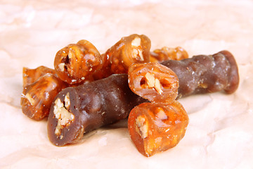 Tasty oriental sweets (churchkhela), on brown background
