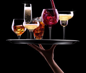 set with different drinks on black background
