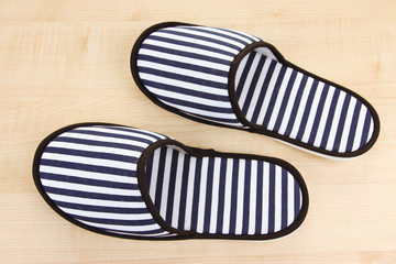 Striped slippers on wooden background