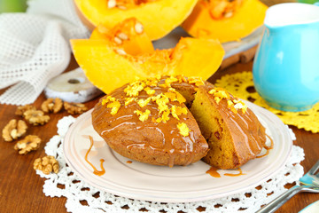 Delicious pumpkin pie on plate on wooden table close-up