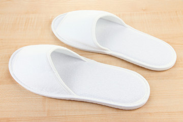 White slippers on wooden background