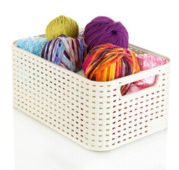 Plastic basket with yarn for knitting isolated on white