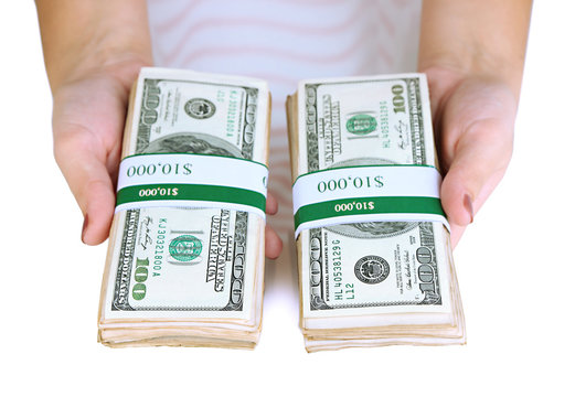 Packs of dollars in hand isolated on white