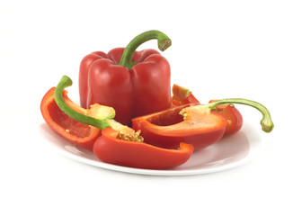 Ripe bell peppers on a plate isolated over white close up