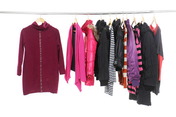 Set of colorful clothes hanging on clothes rack