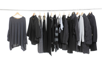 Variety of female fashion clothing hanging on hangers