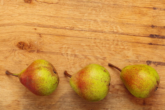 Three pears fruits on wooden table background