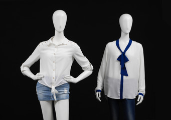 Two mannequin dressed fashionably and isolated on black
