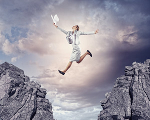 Young businesswoman jumping