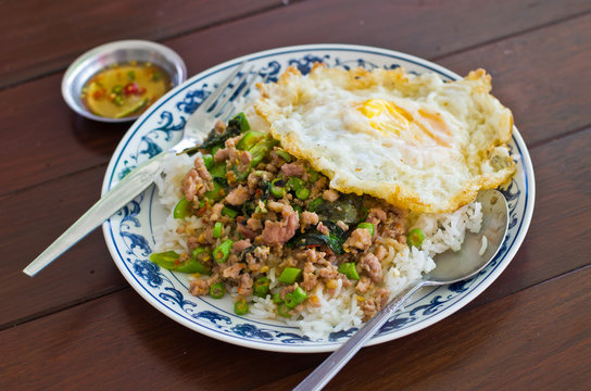 Stir fried pork with basil and egg on rice