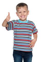 Little boy in striped shirt holds his thumb up