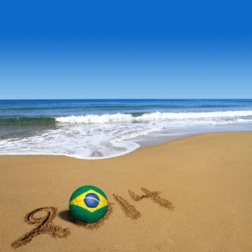 Soccer ball with Brazilian flag and 2014 on beach