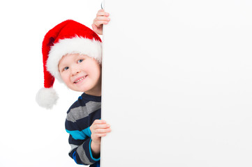 Nice little boy looking over white wall.