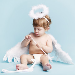 Beautiful little angel on blue background