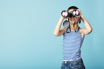 little sailor with binoculars on sky blue background