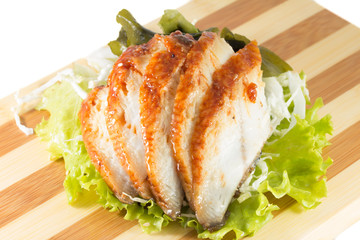 Sliced eel on wooden plate isolated on white background