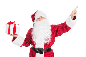 Old funny Santa Claus pointing with finger on empty space.