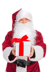 Kind Santa Claus in red costume giving present.