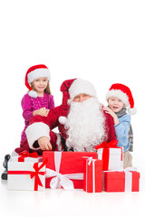 Old Santa Claus surrounded kids and presents