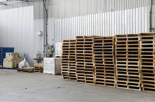 Wooden pallets stacked inside a warehouse