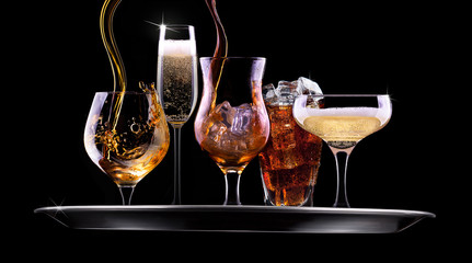 set with different drinks on black background