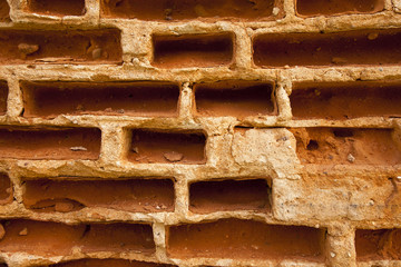 brick wall - the old destroyed wall made of red bricks