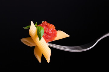 Pasta tomato on fork