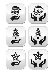 Hands with christmas buttons - santa claus, tree, star