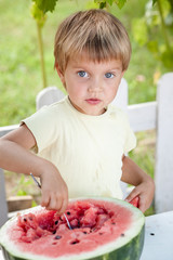 Young blond boy has healthy eating habits